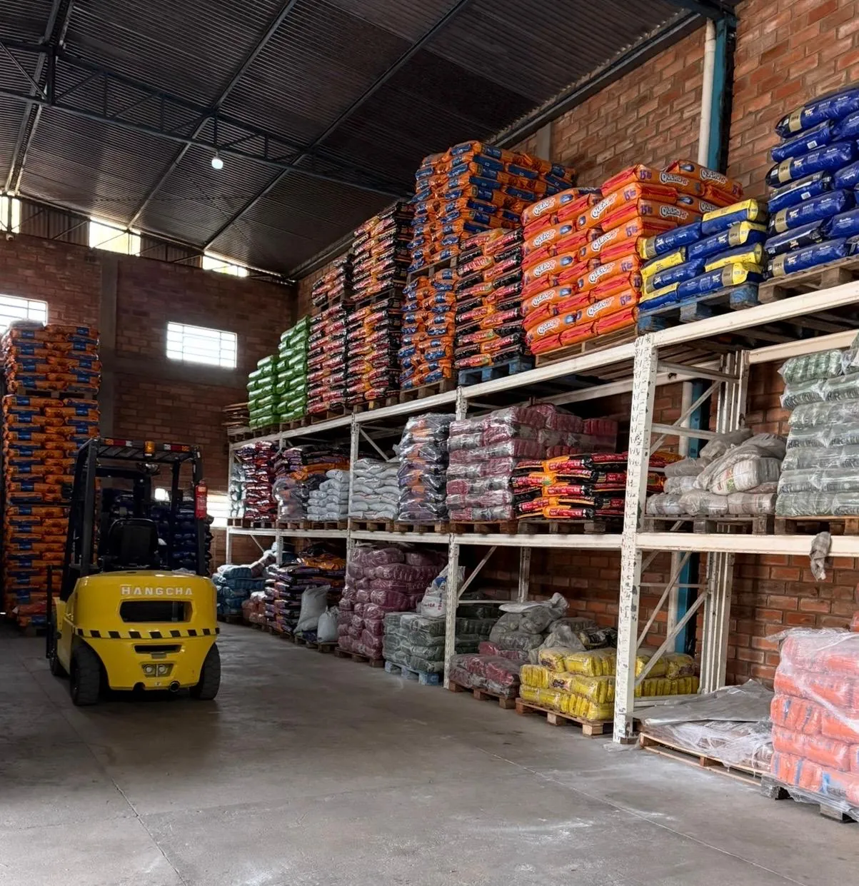 Estantes com sacos de ração organizados no estoque da Agromar